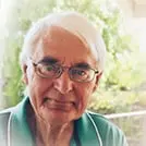 Happy woman holding a bottle of Audifort, sharing a positive review with a cheerful expression, reflecting her satisfaction with the product's natural ingredients and Support Healthy Hearing